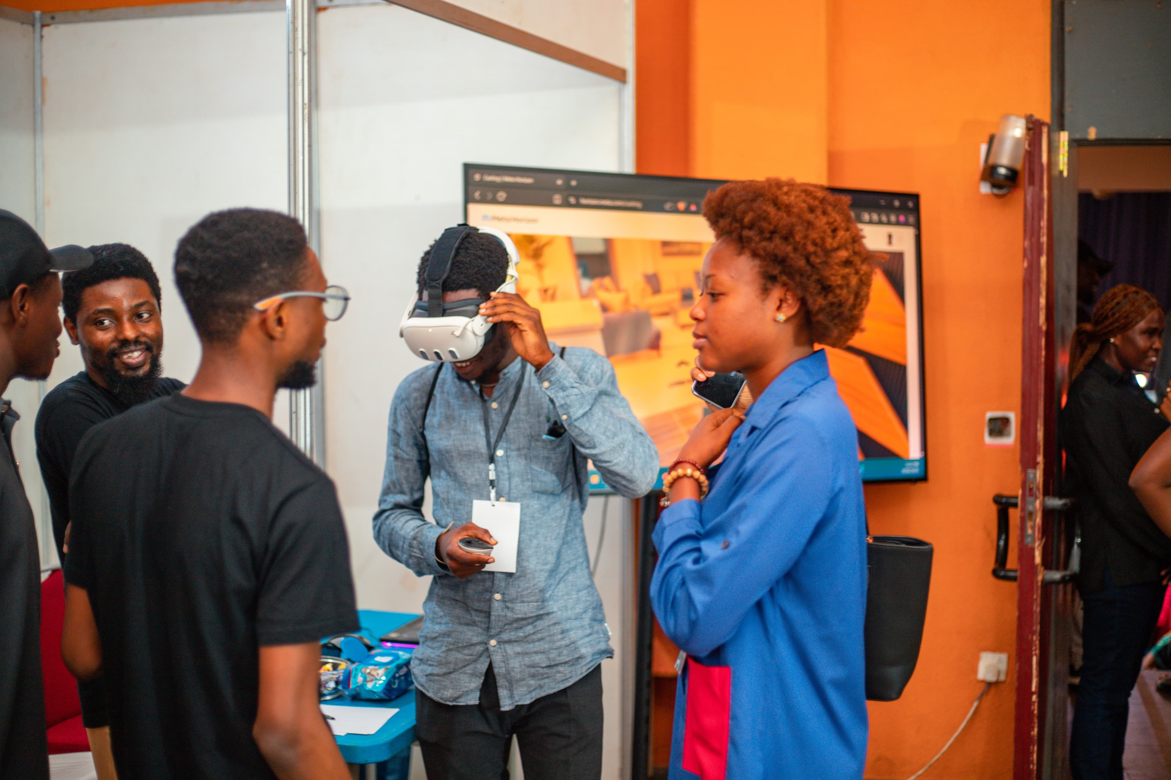A wide shot of the African Creators Conference venue showing attendees and exhibition booths